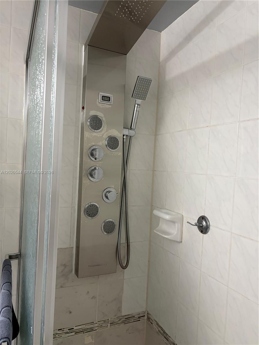 1913 South Ocean Drive, Unit 427 Hallandale Beach, FL 33009 - Photo 13 of 16 a bathroom with a glass shower door