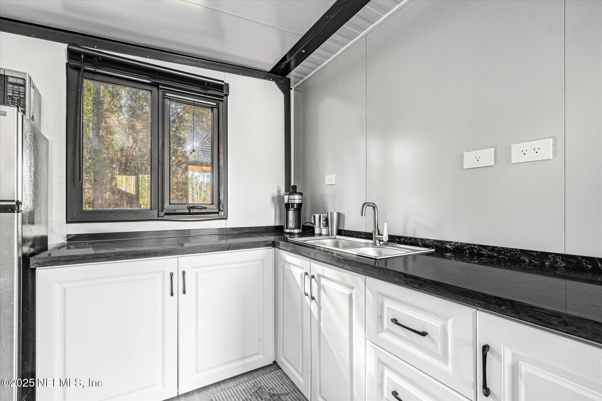 191 County Landfill Road Palatka, FL 32177 - Photo 11 of 37 a kitchen with granite countertop a sink and a stove