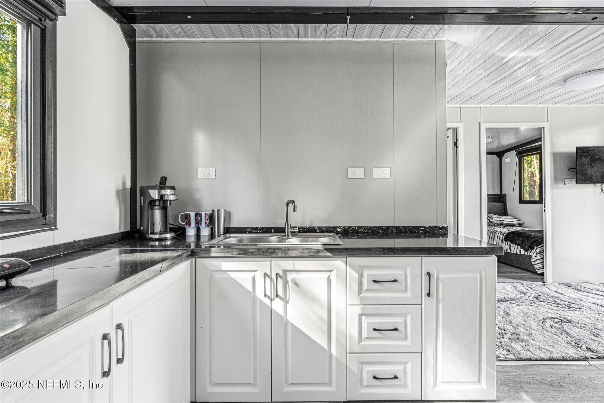 191 County Landfill Road Palatka, FL 32177 - Photo 12 of 37 a kitchen with granite countertop a sink and a stove