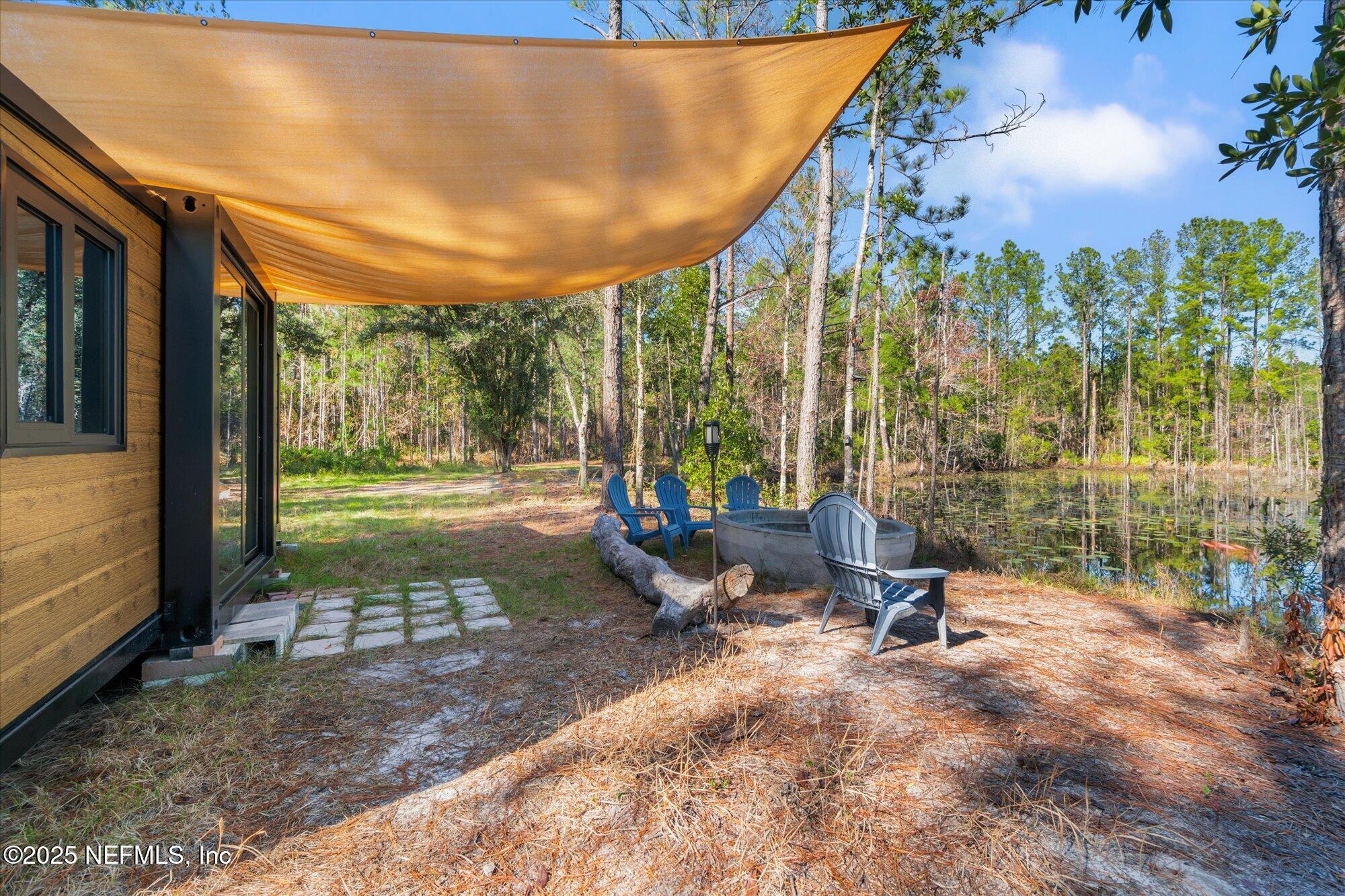 191 County Landfill Road Palatka, FL 32177 - Photo 17 of 37 a view of a swimming pool with a patio and garden