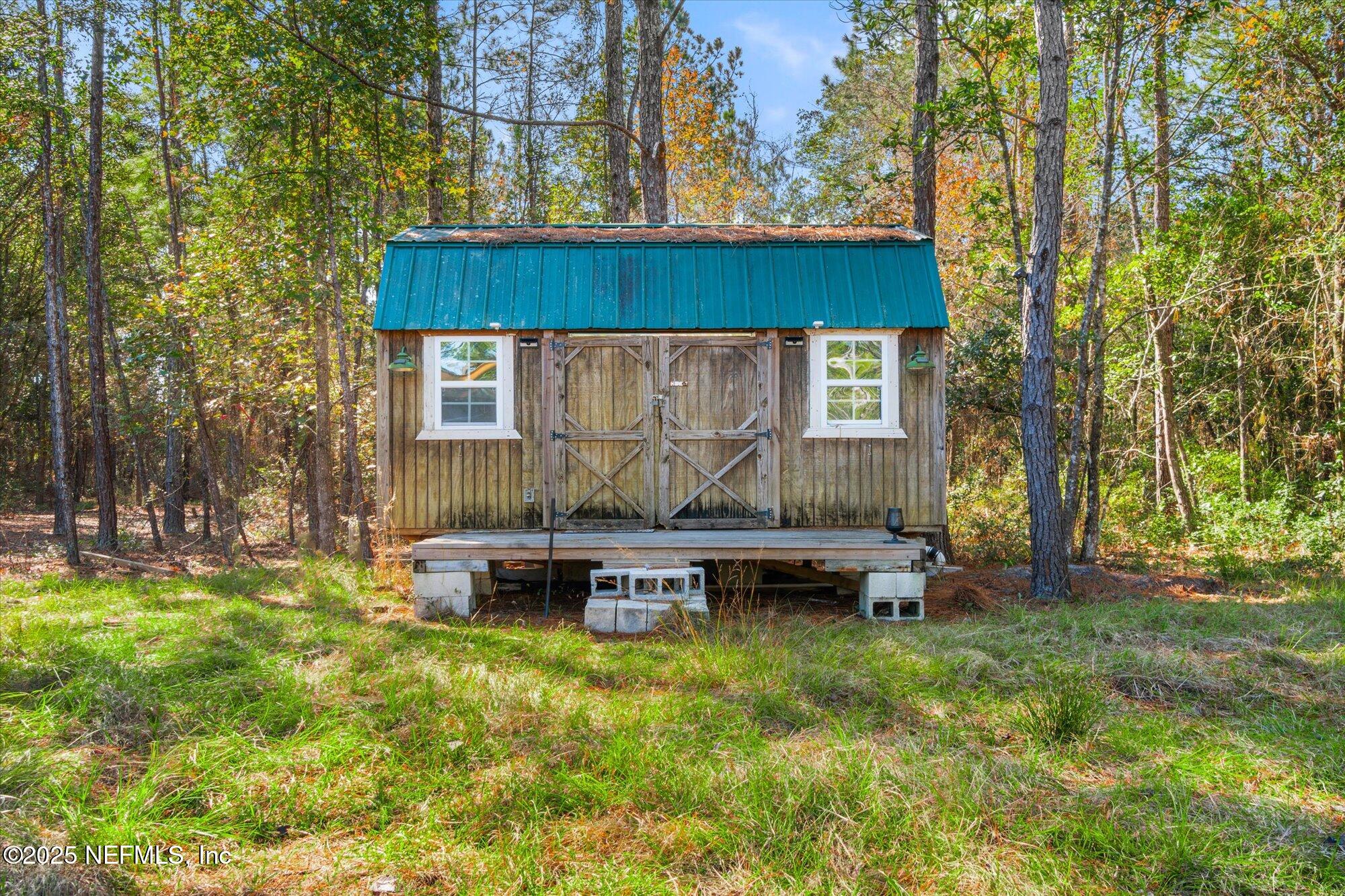 191 County Landfill Road Palatka, FL 32177 - Photo 19 of 37 a front view of a house with a garden and sitting area