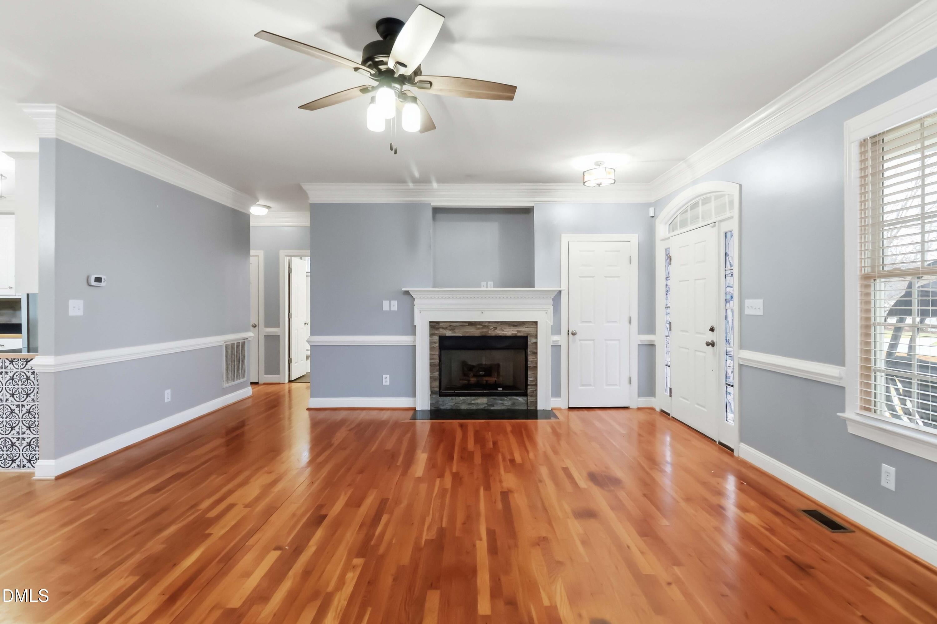 226 Fletcher Ridge Road Timberlake, NC 27583 - Photo 3 of 30 wooden floor fireplace and windows in an empty room