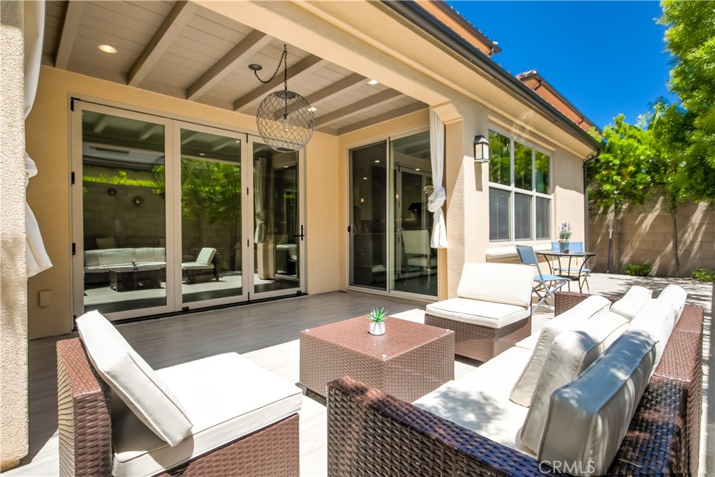 72 Cherry Tree Irvine, CA 92620 - Photo 15 of 15 a view of a patio with couches table and chairs with wooden floor and fence