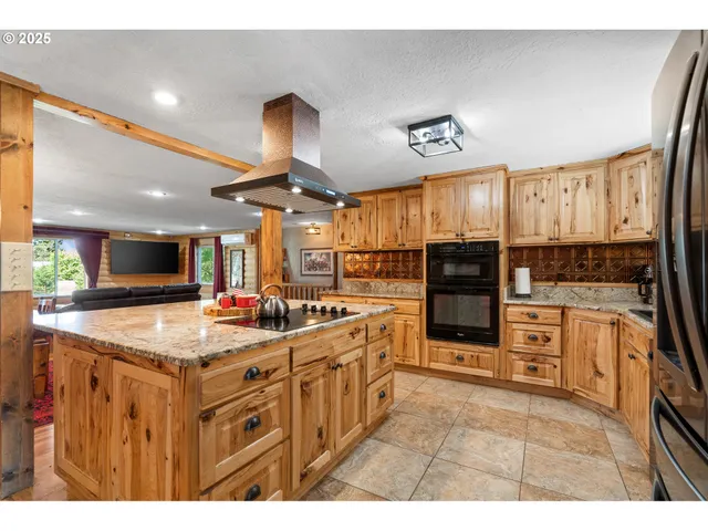 a kitchen with stainless steel appliances granite countertop a sink and cabinets