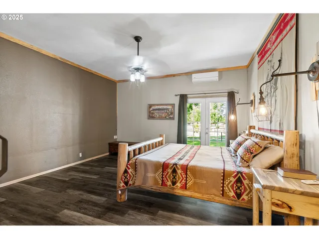 a bedroom with a bed and a chandelier