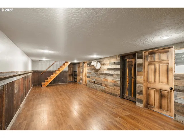 a view of a room with wooden floor