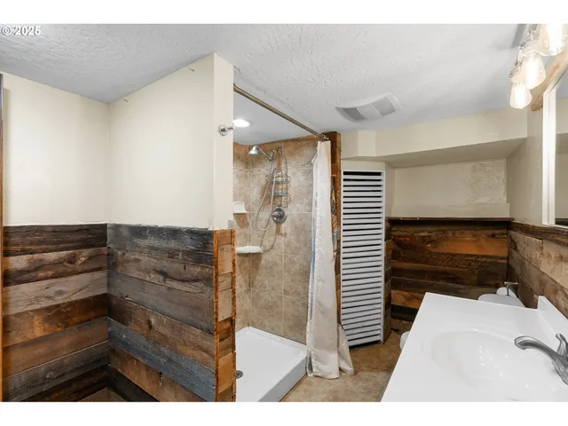 a view of bathroom with a shower and a tub
