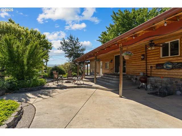 a backyard of a house with yard and outdoor seating