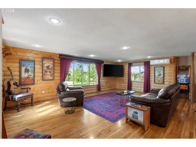 a living room with furniture fireplace and large windows