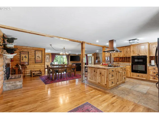 a living room with lots of furniture and kitchen view