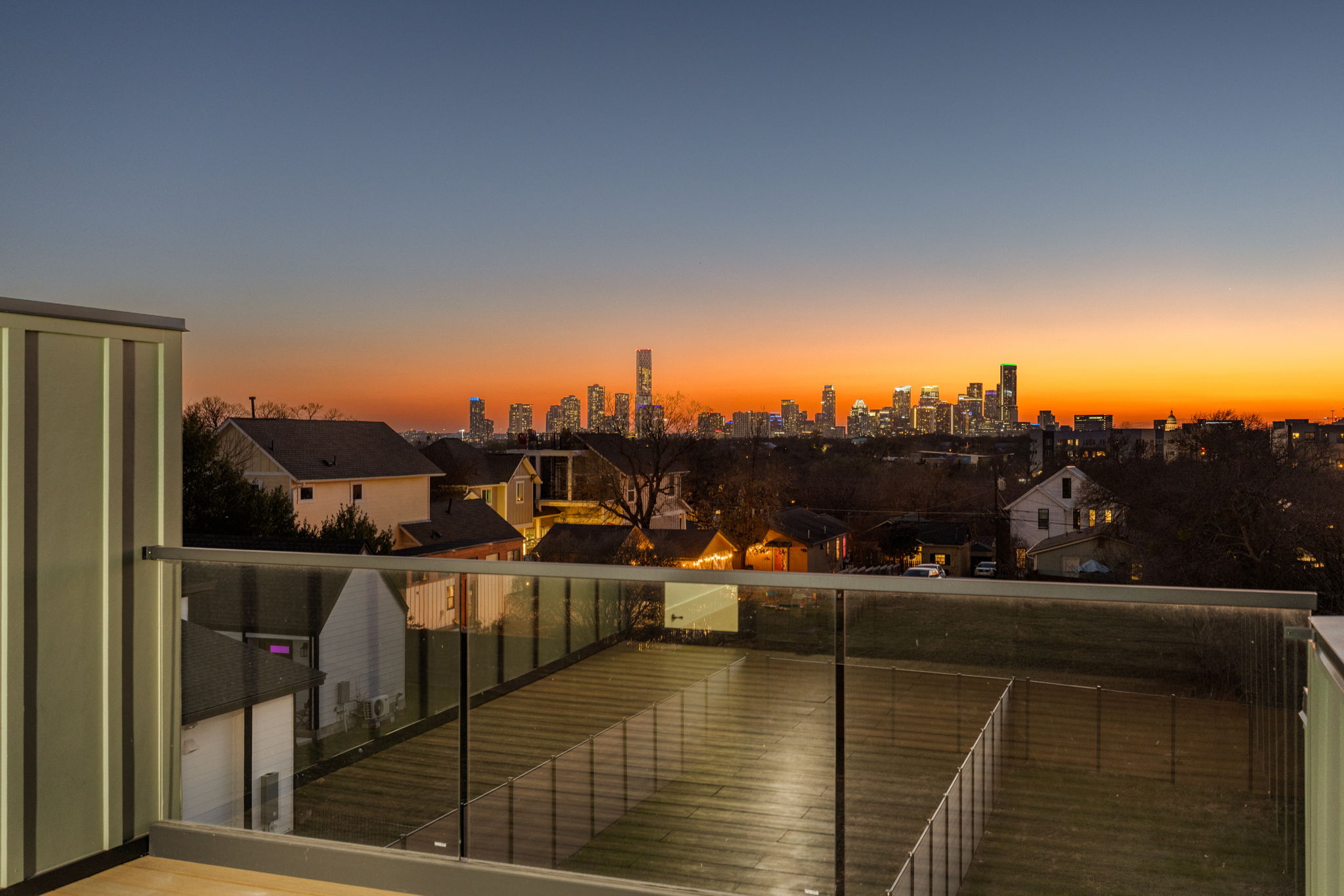 1610 Harvey Street, Unit 1 Austin, TX 78702 - Photo 2 of 39 Balcony at dusk featuring a skyline view