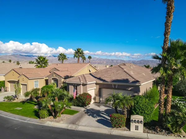an aerial view of multiple houses with a yard