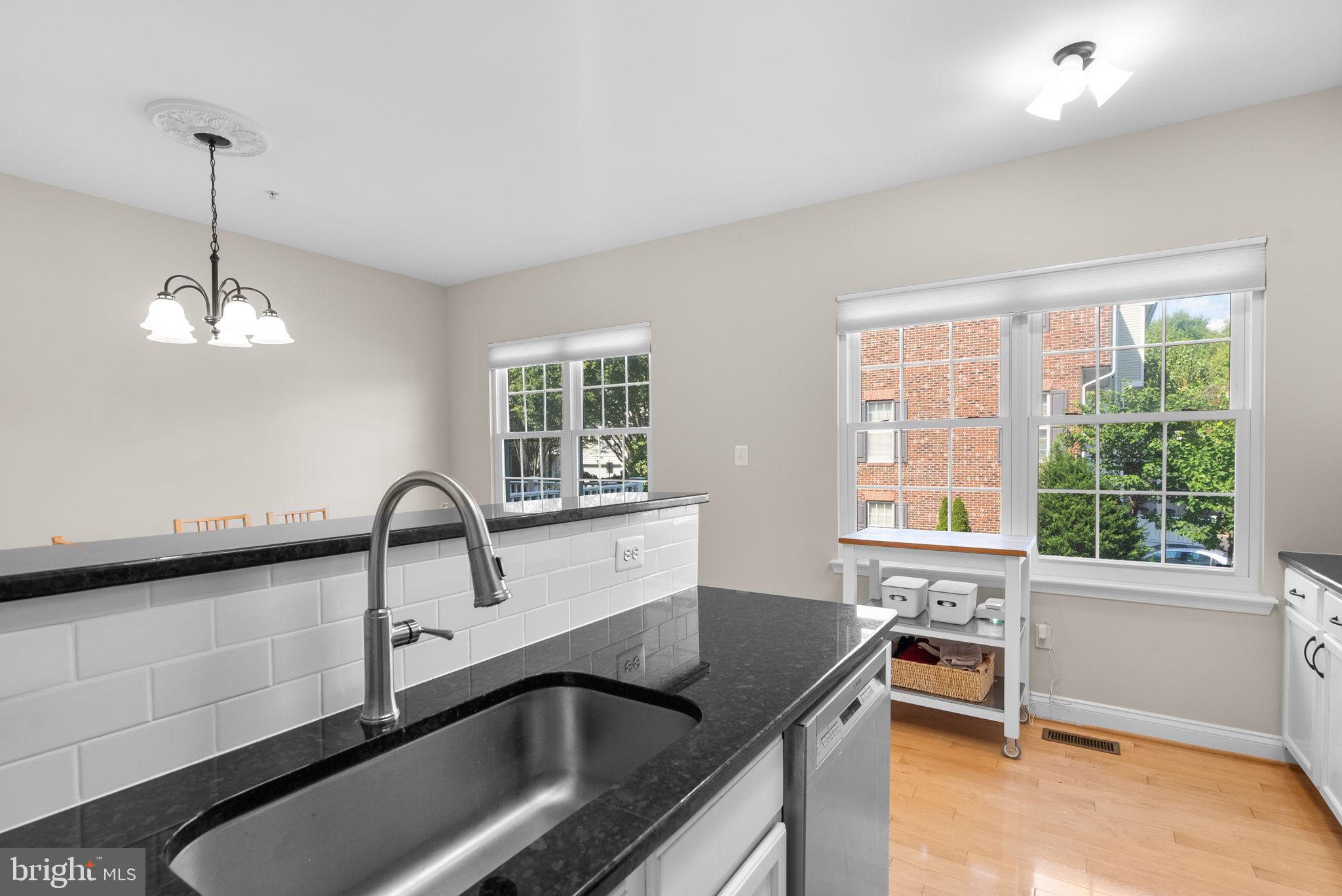 215 Poplar Spring Road Rockville, MD 20850 - Photo 12 of 30 a kitchen with granite countertop a sink and a stove