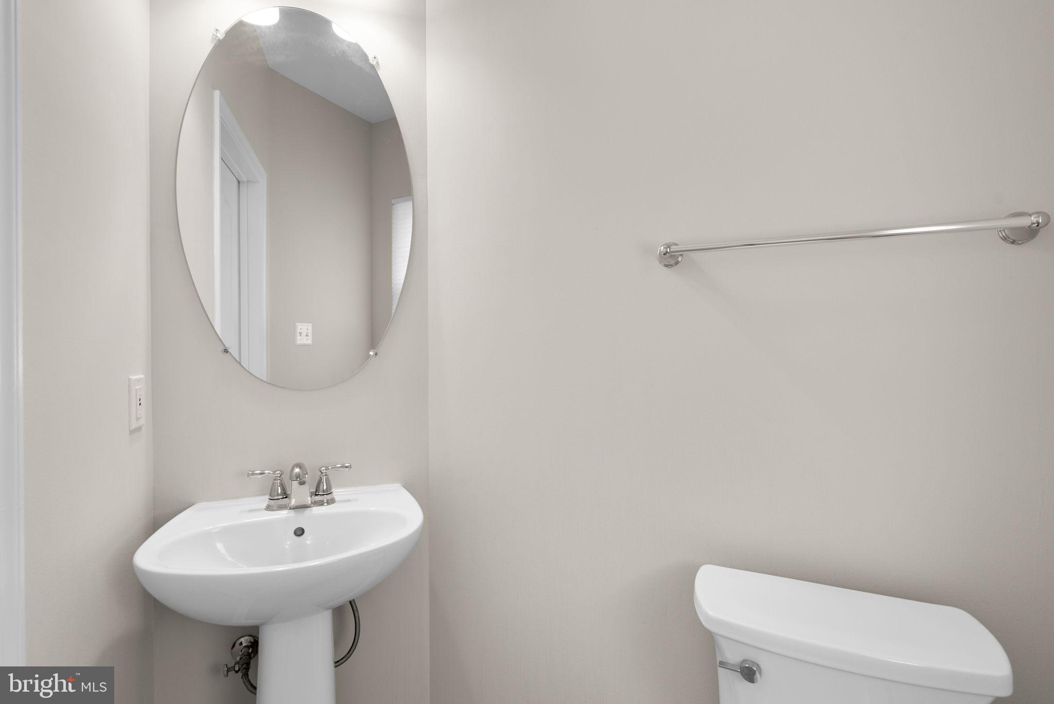 215 Poplar Spring Road Rockville, MD 20850 - Photo 13 of 30 a bathroom with a sink a toilet and mirror