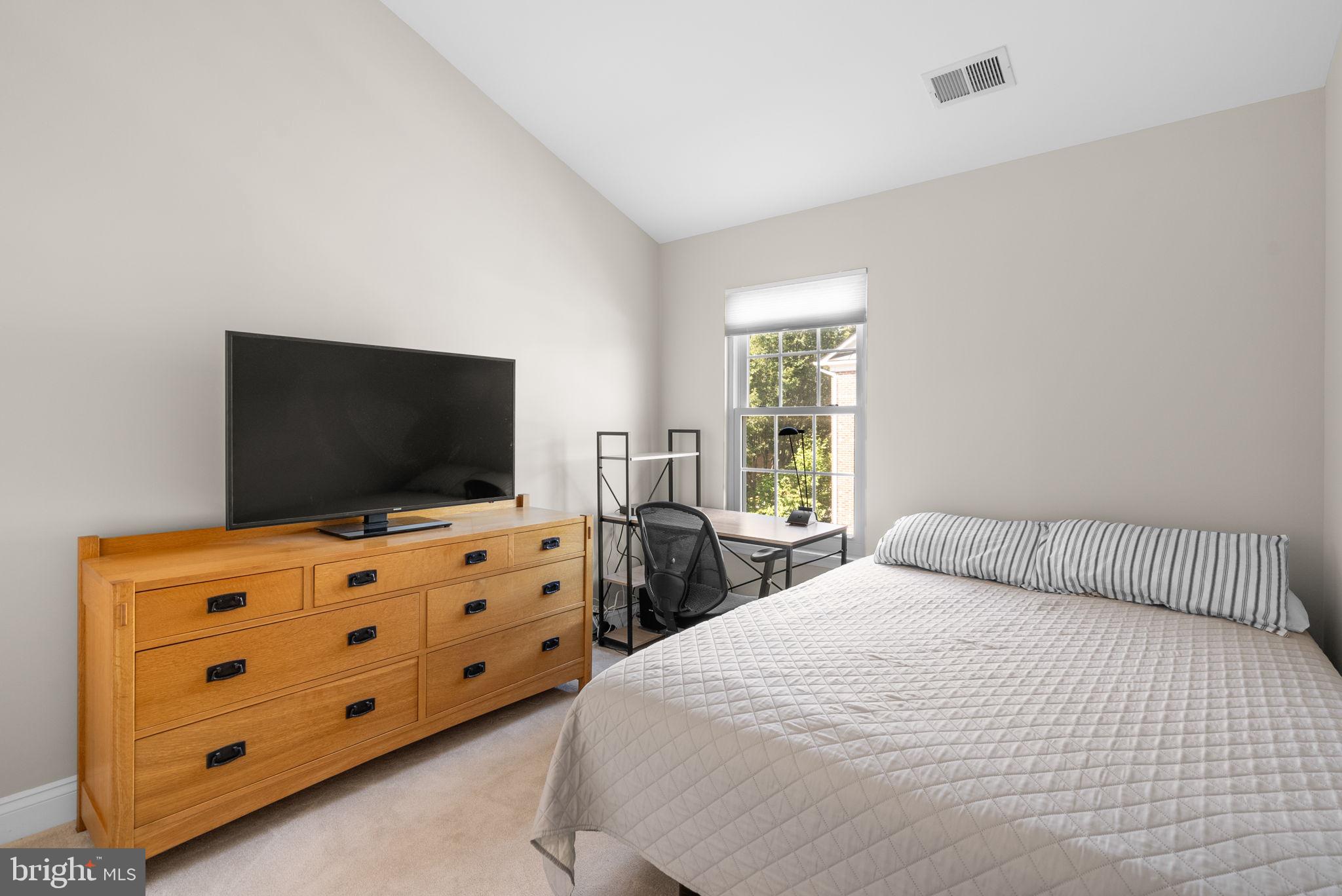 215 Poplar Spring Road Rockville, MD 20850 - Photo 20 of 30 a bedroom with a bed and a flat screen tv