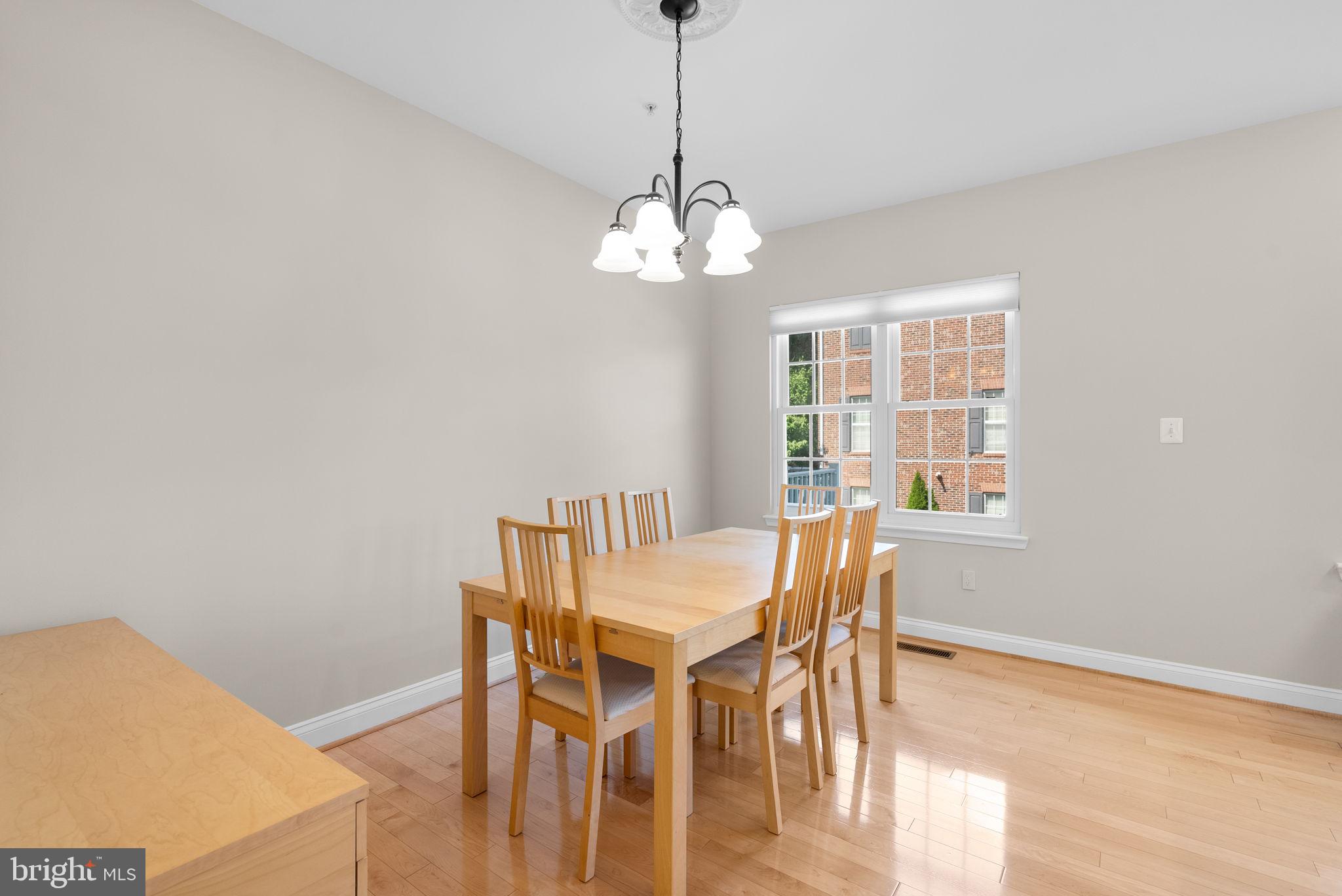 215 Poplar Spring Road Rockville, MD 20850 - Photo 6 of 30 a view of a dining room with furniture wooden floor and a chandelier