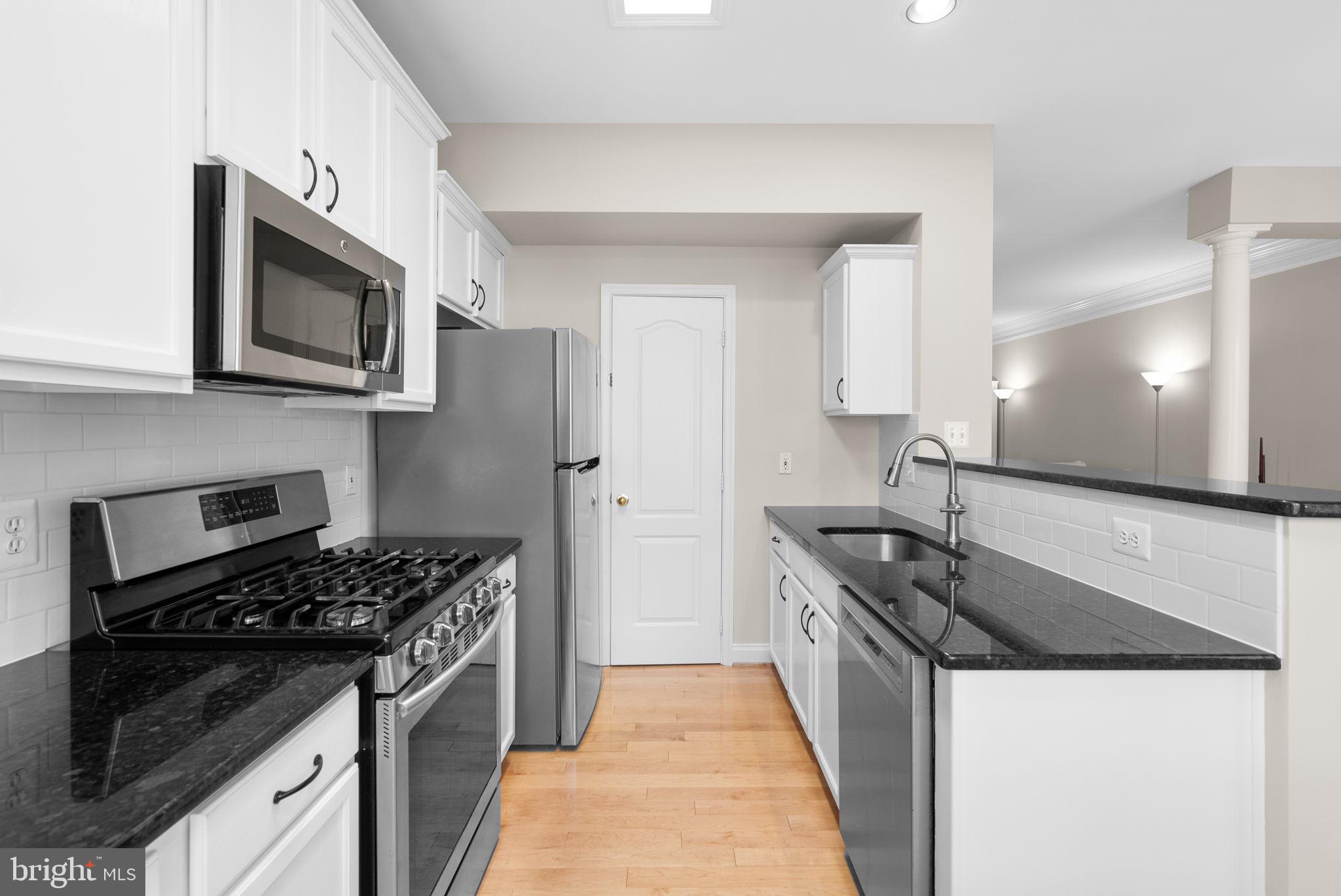 215 Poplar Spring Road Rockville, MD 20850 - Photo 10 of 30 a kitchen with stainless steel appliances granite countertop a stove and a microwave
