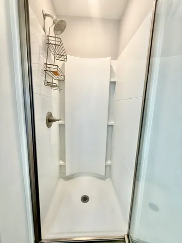 a bathroom with a tub and shower