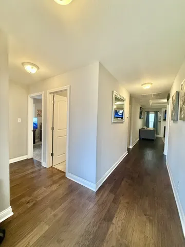 a view of a living room with wooden floor