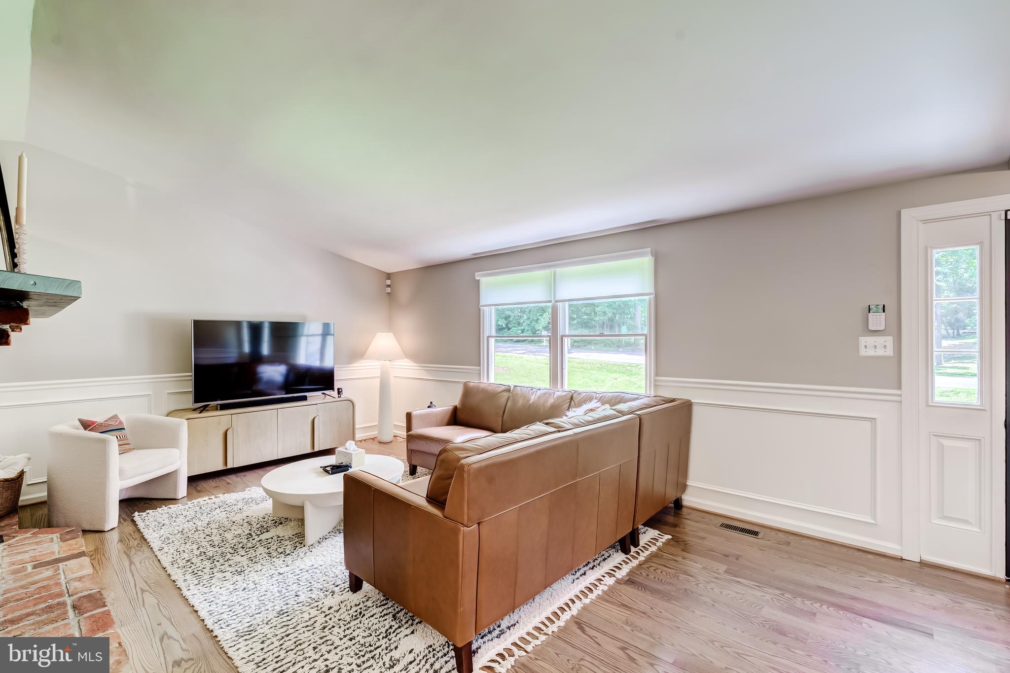 11926 Appling Valley Road Fairfax, VA 22030 - Photo 18 of 60 a living room with furniture and a flat screen tv
