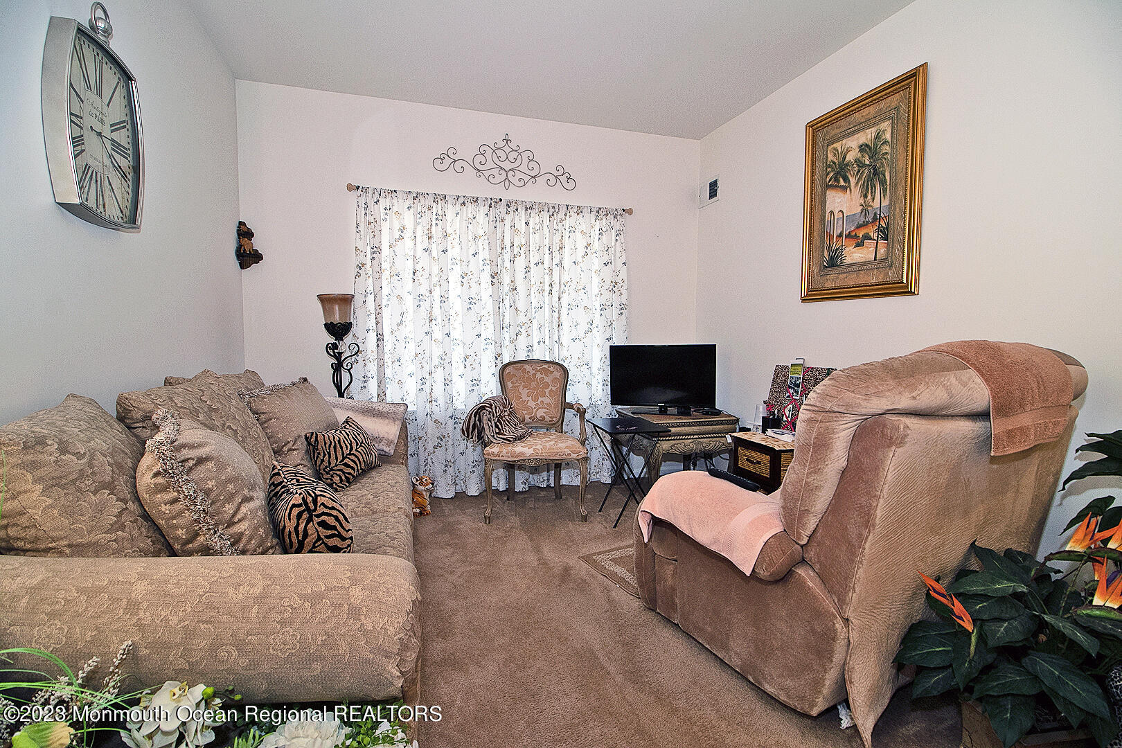 27 Pancoast Road Waretown, NJ 08758 - Photo 11 of 37 a living room with furniture a flat screen tv and a large window