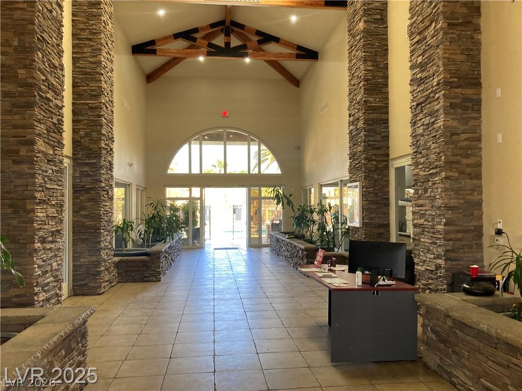 9050 West Warm Springs Road, Unit 1027 Las Vegas, NV 89148 - Photo 34 of 44 Grand stone columns and exposed beam ceilings create a striking entry to this property.
