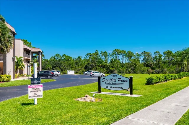 a garden with a bench in front of the house