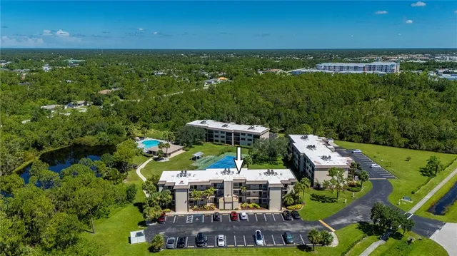an aerial view of a house with garden space and street view