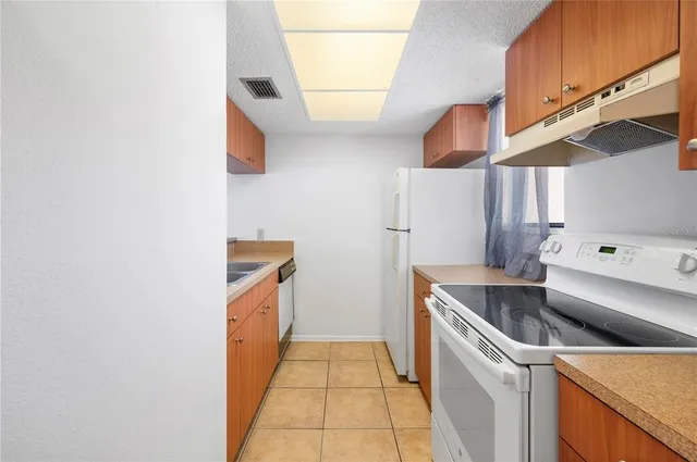 a kitchen with sink and large window