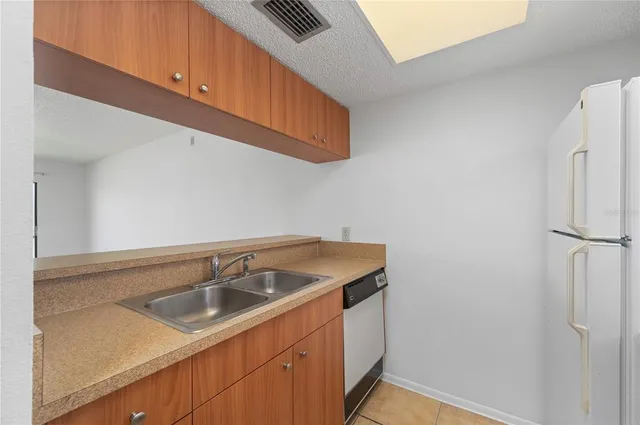 a kitchen with a sink and a refrigerator