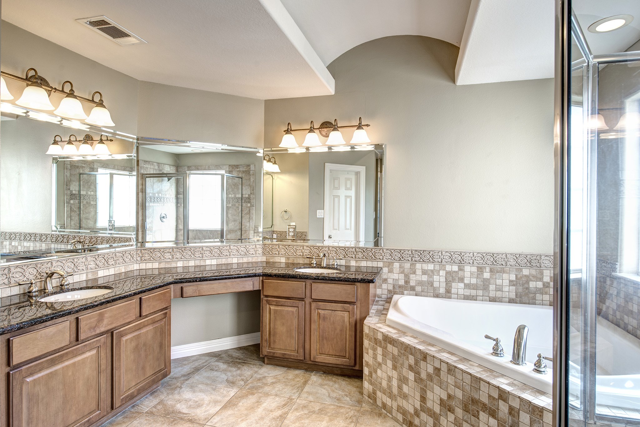 4003 Feagan Street, Unit 2 Houston, TX 77007 - Photo 17 of 25 Spa-like primary bath with granite counter, double sinks, vanity, whirlpool tub and walk-in shower.