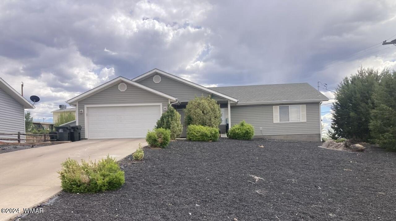 337 West Spruce Lane Snowflake, AZ 85937 - Photo 1 of 1 a front view of a house with a yard and garage