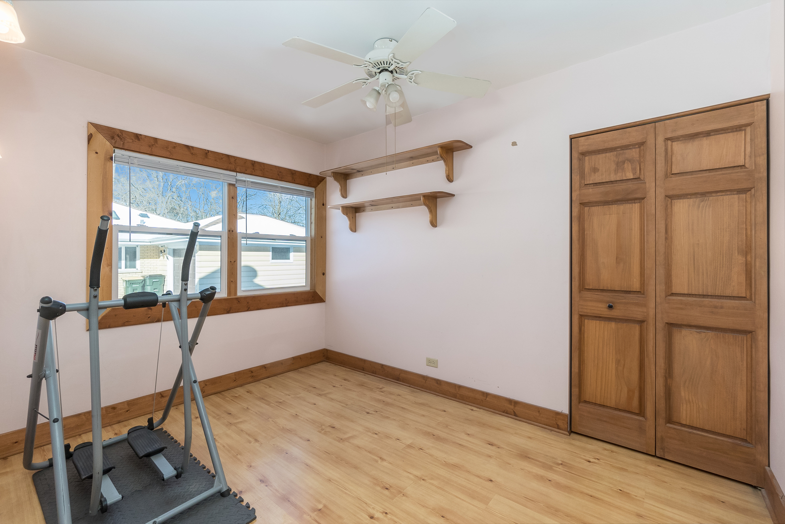 28W418 Batavia Road Warrenville, IL 60555 - Photo 11 of 24 a view of a room with gym equipment and a window