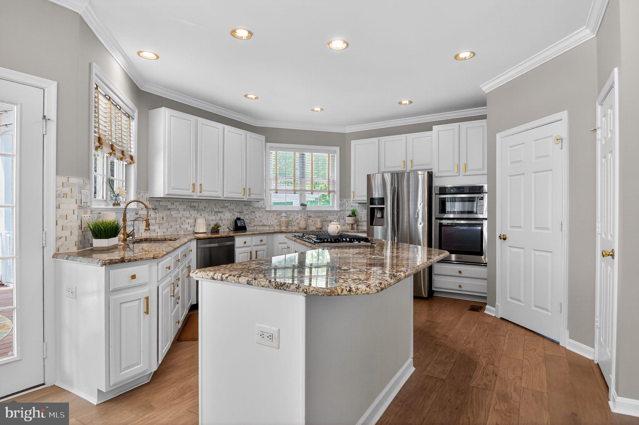 90 Oxford Way Huntingtown, MD 20639 - Photo 14 of 32 a kitchen with refrigerator and cabinets