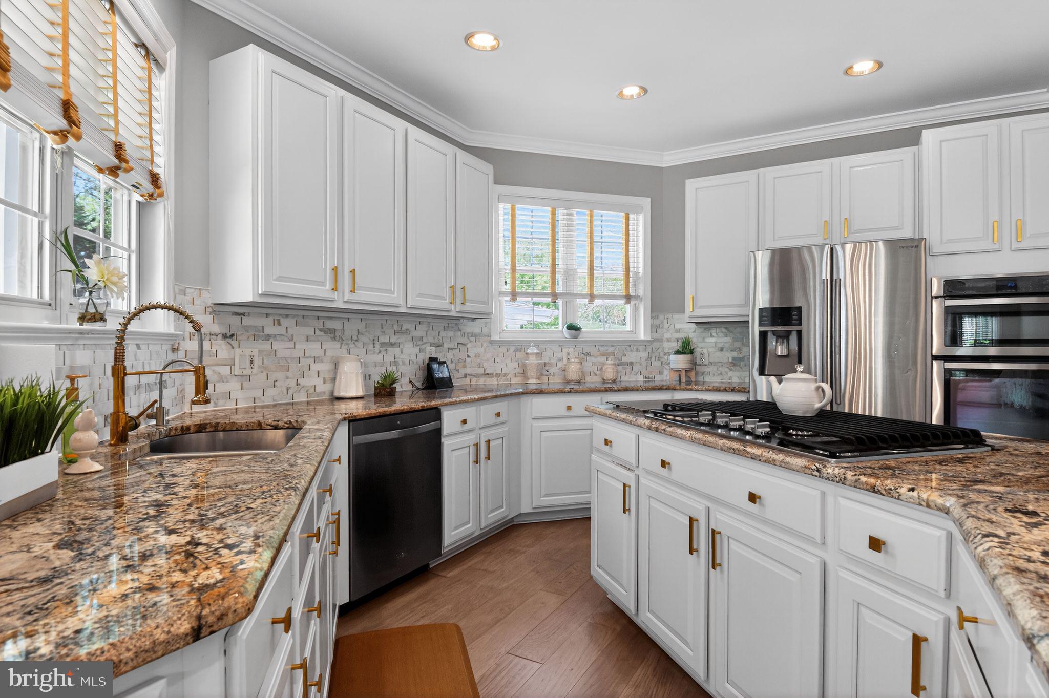 90 Oxford Way Huntingtown, MD 20639 - Photo 15 of 32 a kitchen with granite countertop a sink stainless steel appliances and white cabinets