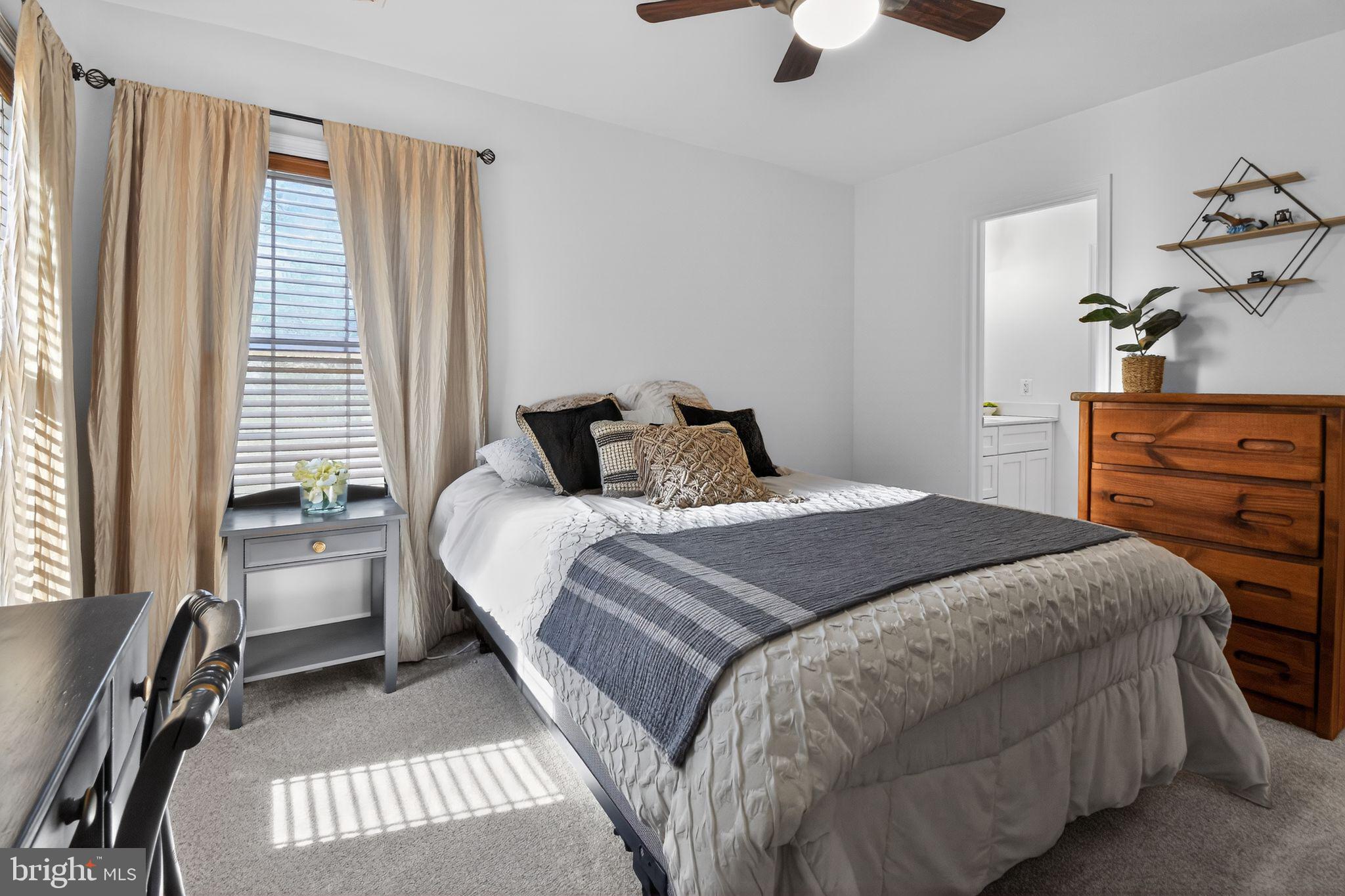 90 Oxford Way Huntingtown, MD 20639 - Photo 24 of 32 a bedroom with a bed and a chandelier