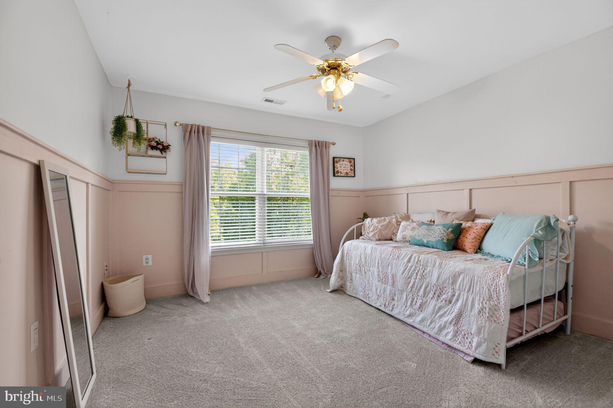 90 Oxford Way Huntingtown, MD 20639 - Photo 25 of 32 a spacious bedroom with a bed and a chandelier