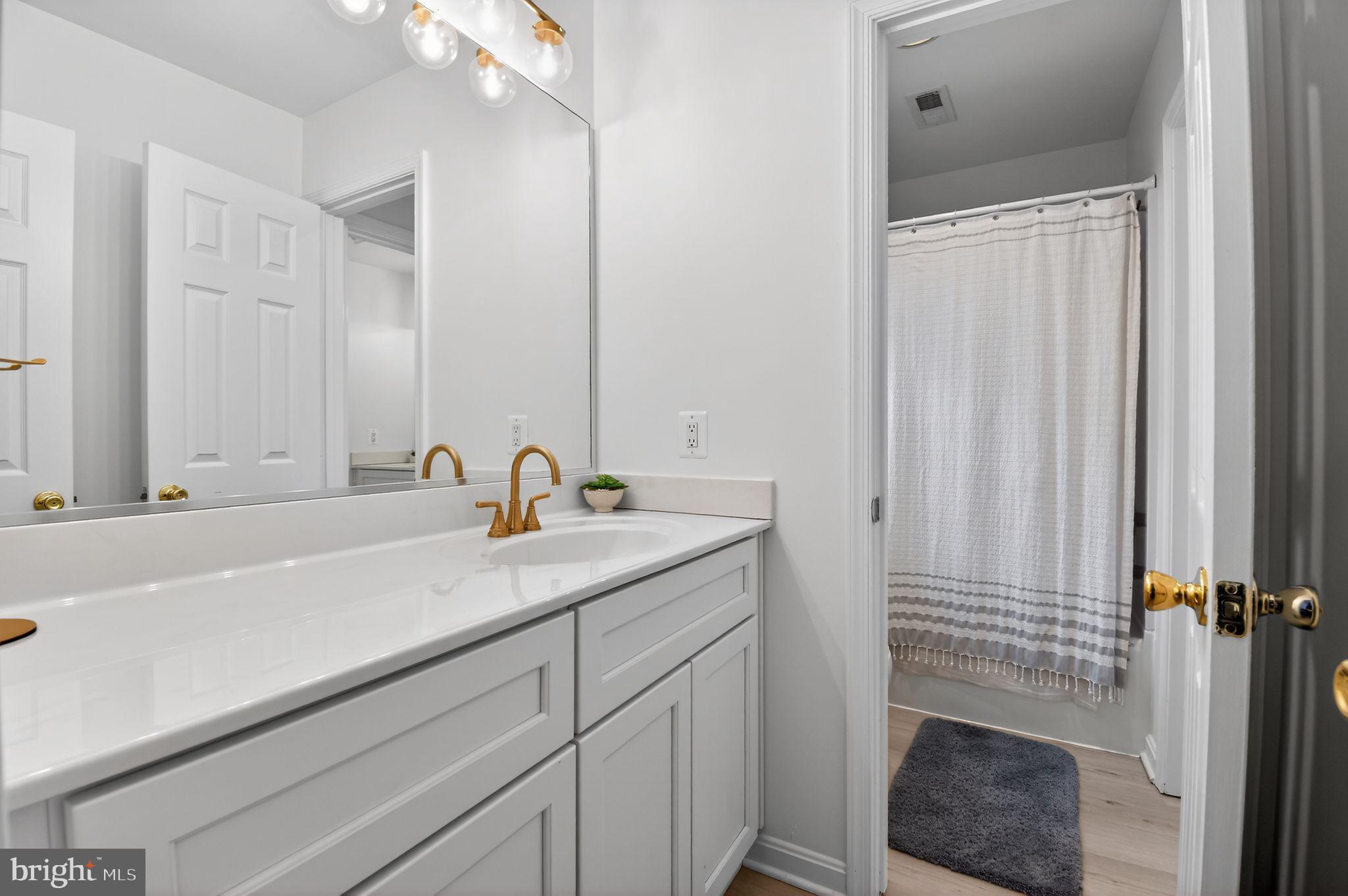 90 Oxford Way Huntingtown, MD 20639 - Photo 27 of 32 a bathroom with a sink and a mirror