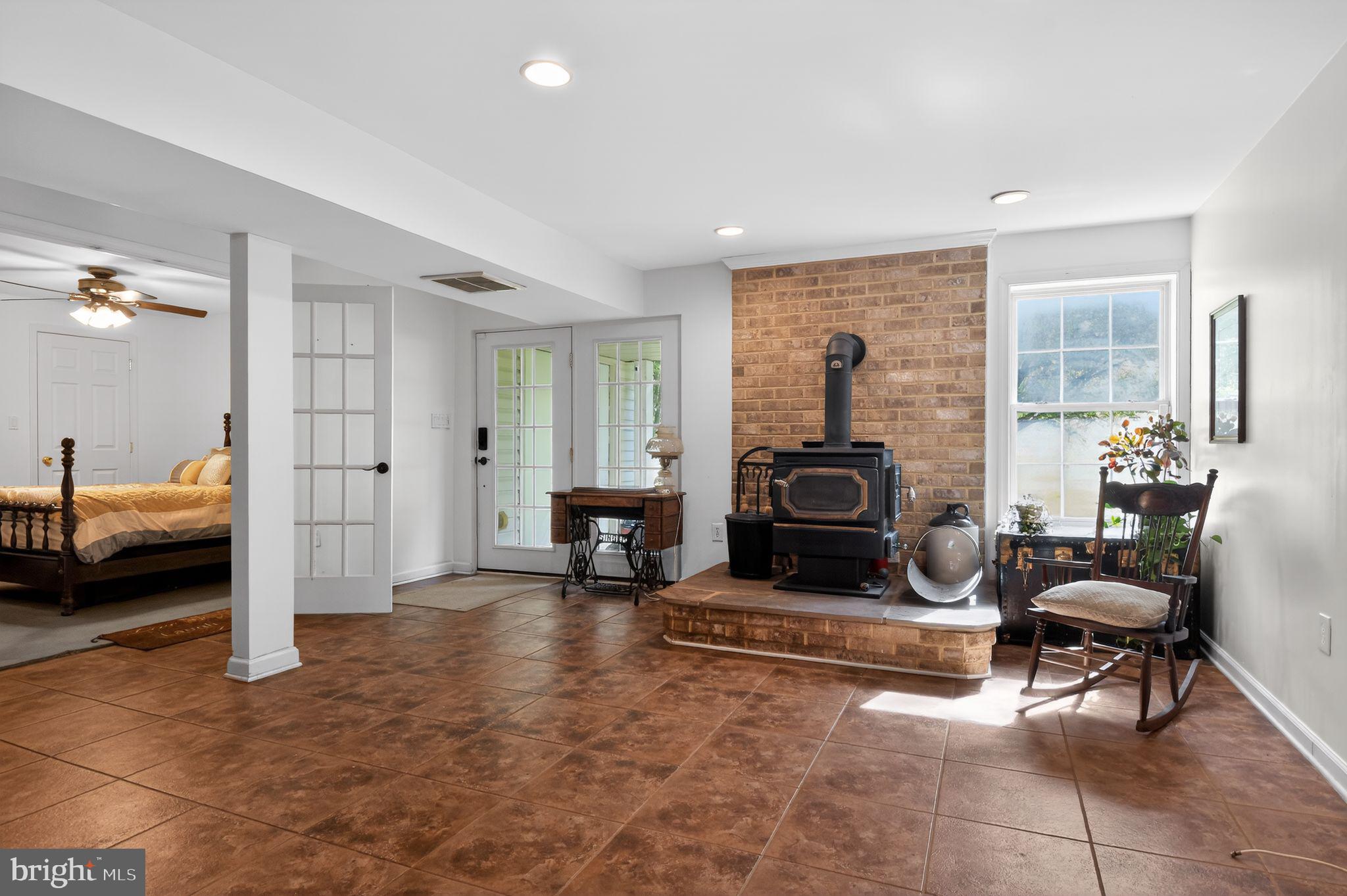 90 Oxford Way Huntingtown, MD 20639 - Photo 29 of 32 a living room with furniture and a fireplace