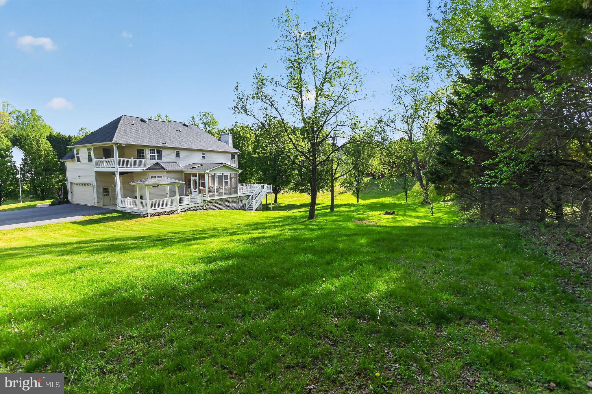 90 Oxford Way Huntingtown, MD 20639 - Photo 3 of 32 a view of a house with a big yard and large trees