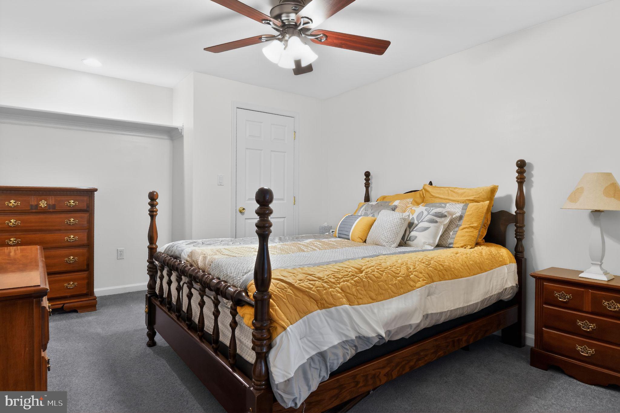 90 Oxford Way Huntingtown, MD 20639 - Photo 32 of 32 a bedroom with a bed and a chandelier