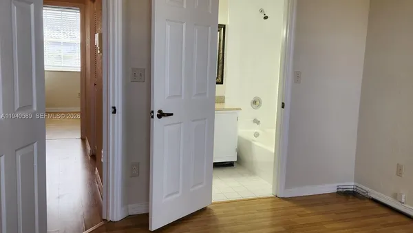 a bathroom with a granite countertop toilet a sink and a mirror