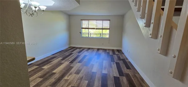 a view of a room with wooden floor and staircase