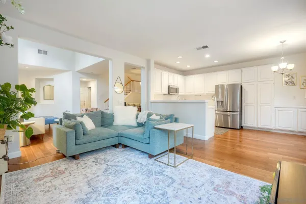 a living room with furniture and a kitchen view