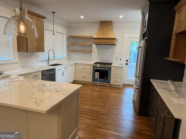 a kitchen with a sink a stove and a refrigerator