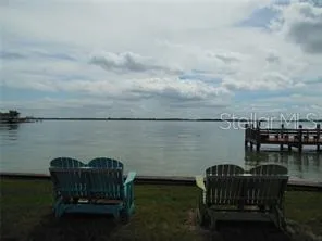 a view of swimming pool with outdoor seating city and lake view