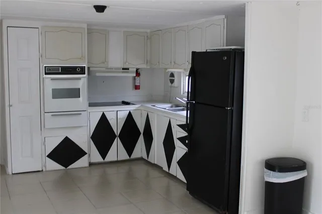 a kitchen with a refrigerator and cabinets