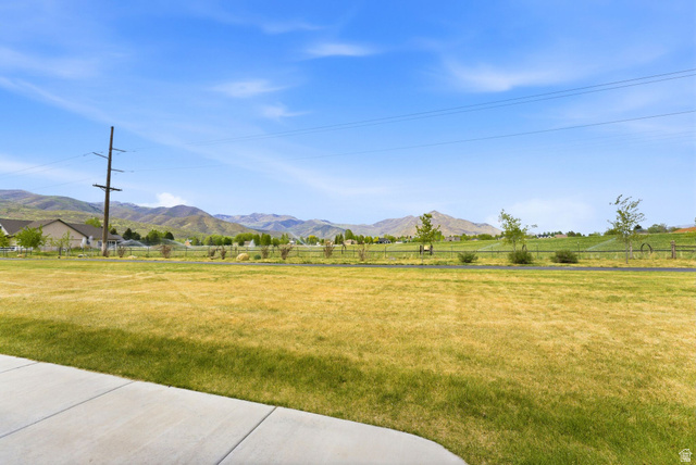 108 West Monte Rosa Lane Midway, UT 84049 - Photo 42 of 48 Expansive green space with distant mountain scenery, featuring a paved pathway and partial residential structures