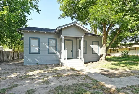 a view of a house with yard and a tree