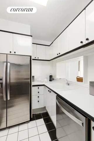 a kitchen with stainless steel appliances a sink stove and cabinets